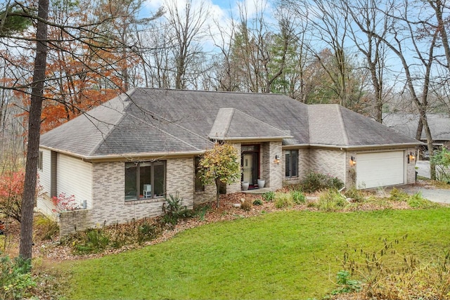 view of front of home with a garage and a front yard