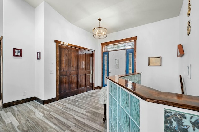 entryway with hardwood / wood-style flooring and an inviting chandelier