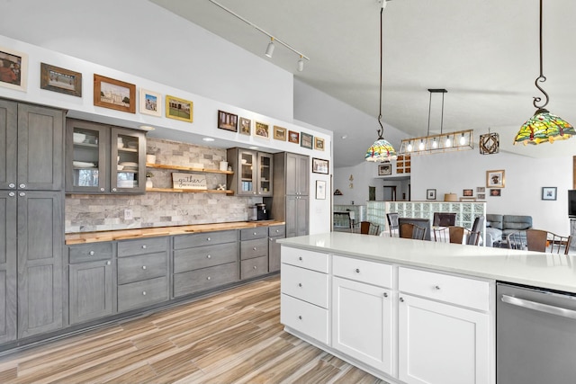 kitchen featuring gray cabinetry, tasteful backsplash, hanging light fixtures, dishwasher, and white cabinets