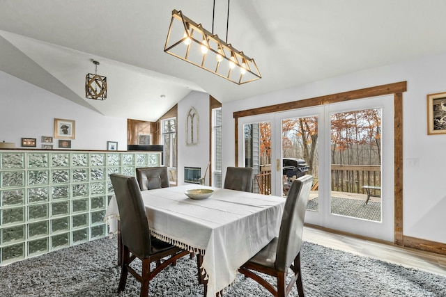 dining area featuring lofted ceiling and hardwood / wood-style floors