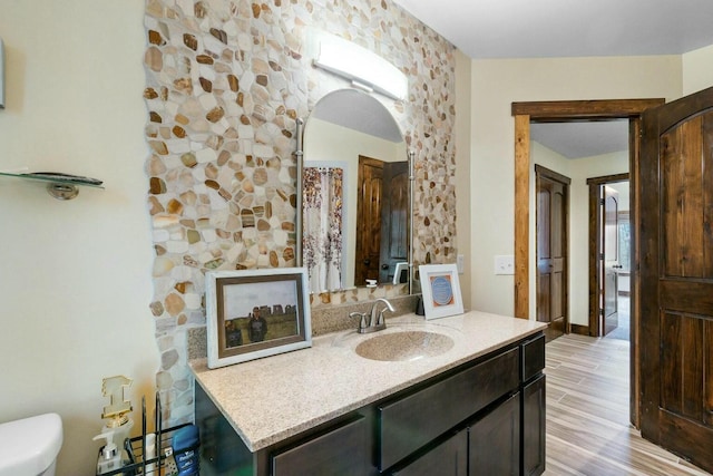 bathroom featuring hardwood / wood-style flooring, vanity, and toilet