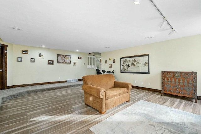 living room featuring hardwood / wood-style flooring and rail lighting