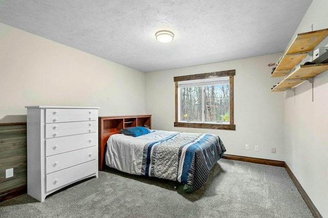 carpeted bedroom featuring a textured ceiling