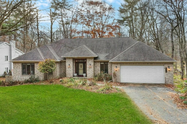 ranch-style house featuring a garage and a front yard