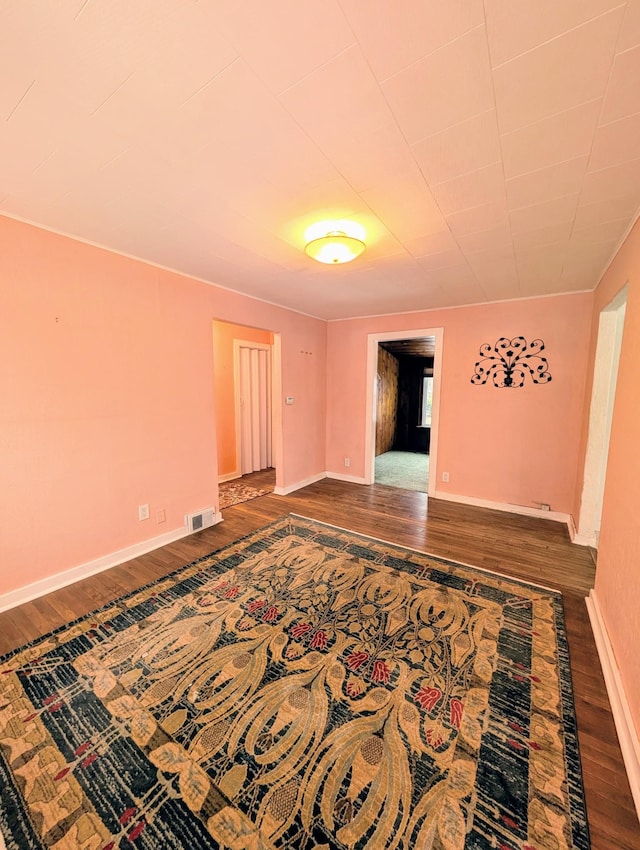 spare room featuring wood-type flooring