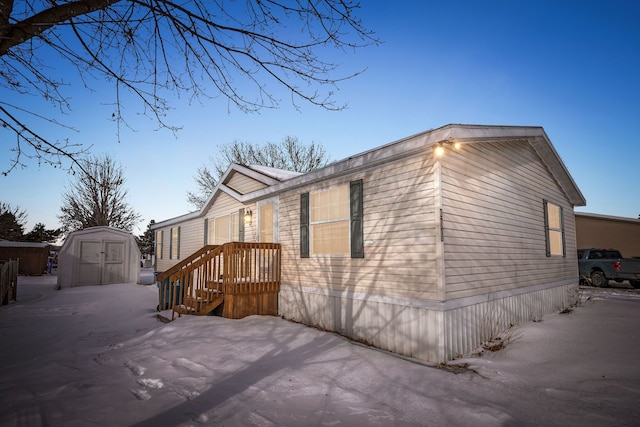 view of side of home featuring a storage shed