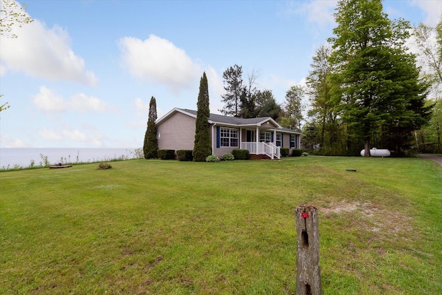 ranch-style home with a front lawn and a water view