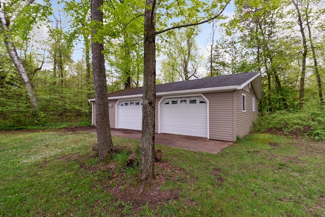 garage featuring a lawn