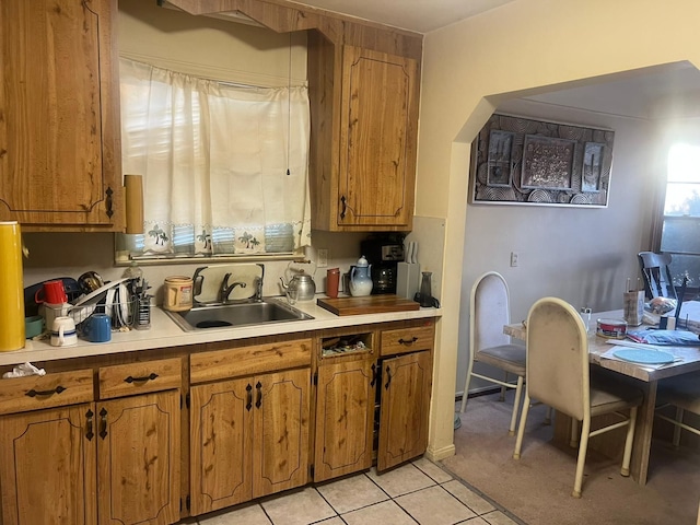 kitchen featuring light tile patterned flooring and sink