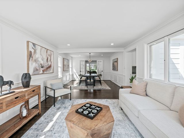 living room featuring hardwood / wood-style floors and crown molding