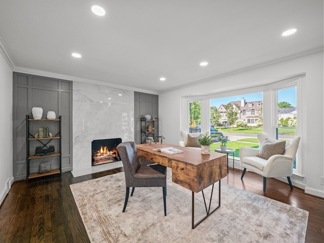 office area featuring crown molding, a fireplace, and dark hardwood / wood-style floors