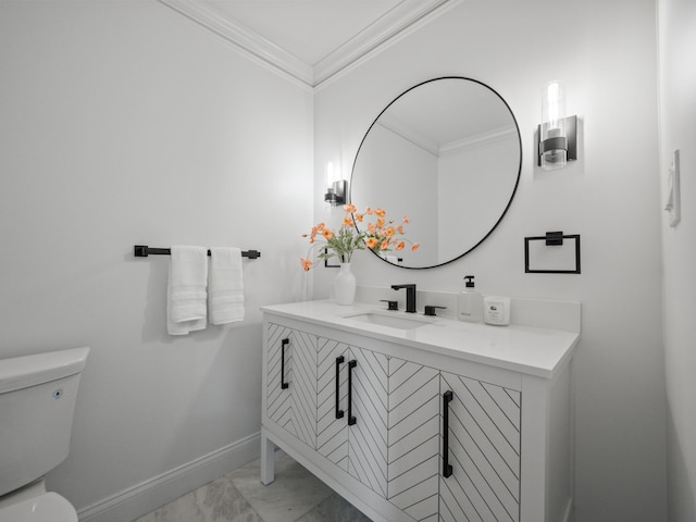 bathroom with vanity, ornamental molding, and toilet