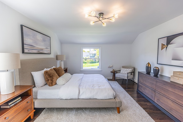 bedroom featuring lofted ceiling and dark wood-type flooring