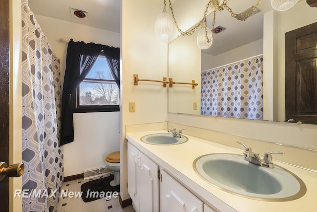 bathroom featuring vanity and toilet