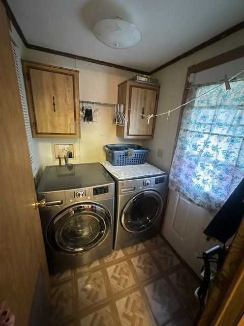 clothes washing area featuring cabinets, washing machine and dryer, light parquet floors, and crown molding