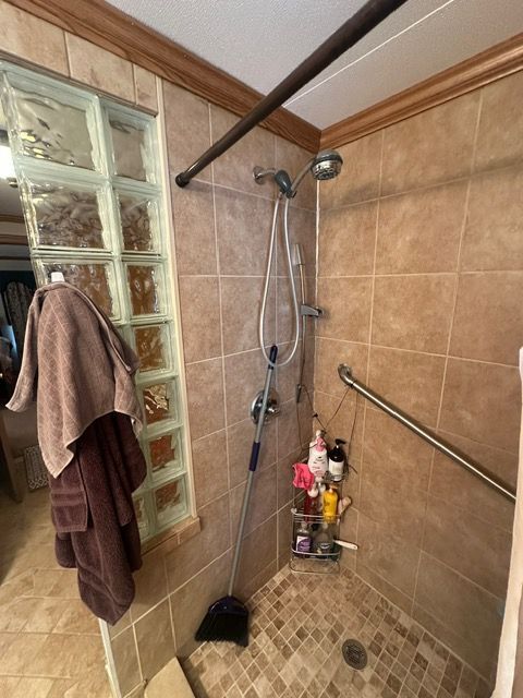 bathroom with a tile shower