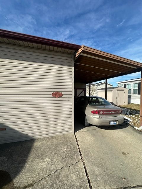 view of vehicle parking featuring a carport