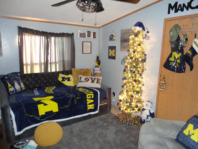 carpeted bedroom featuring crown molding and ceiling fan