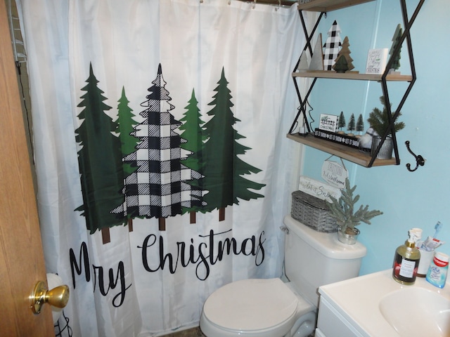 bathroom featuring vanity and toilet