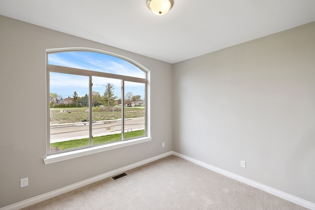 unfurnished room featuring carpet flooring