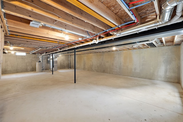 basement featuring heating unit and water heater