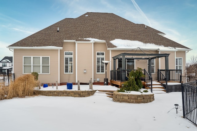 snow covered back of property featuring a gazebo