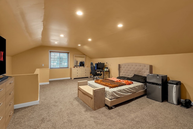 bedroom with vaulted ceiling, light colored carpet, and stainless steel fridge