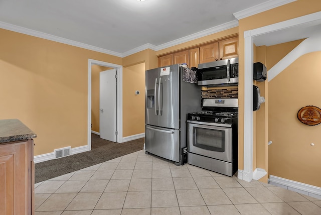 kitchen featuring crown molding, stainless steel appliances, decorative backsplash, and light tile patterned floors