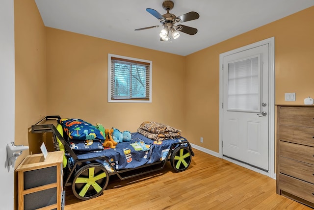 bedroom with light hardwood / wood-style floors and ceiling fan