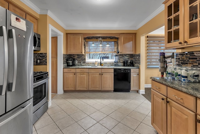 kitchen with dark stone countertops, sink, crown molding, and stainless steel appliances