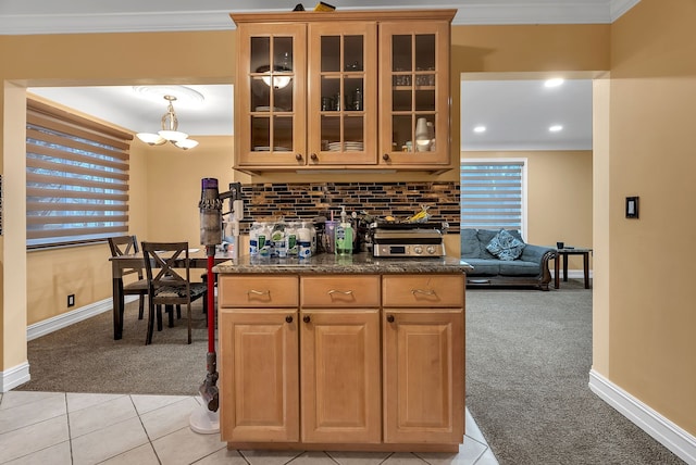 kitchen with decorative light fixtures, backsplash, light colored carpet, a notable chandelier, and crown molding