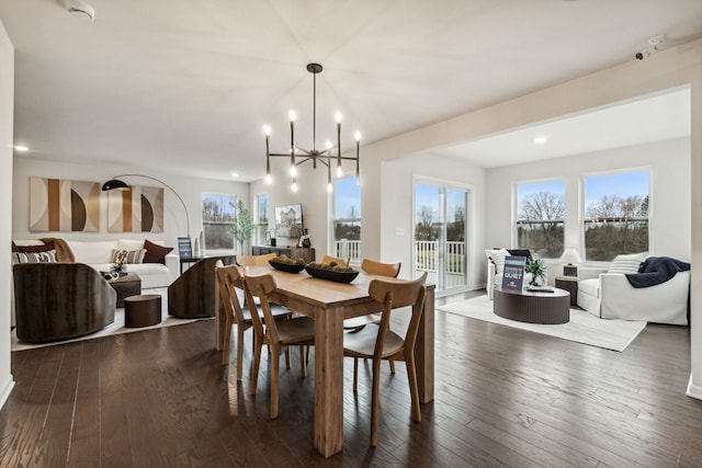 dining room featuring dark hardwood / wood-style floors and a chandelier