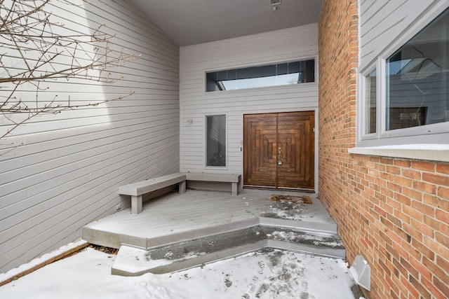 doorway to property featuring brick siding