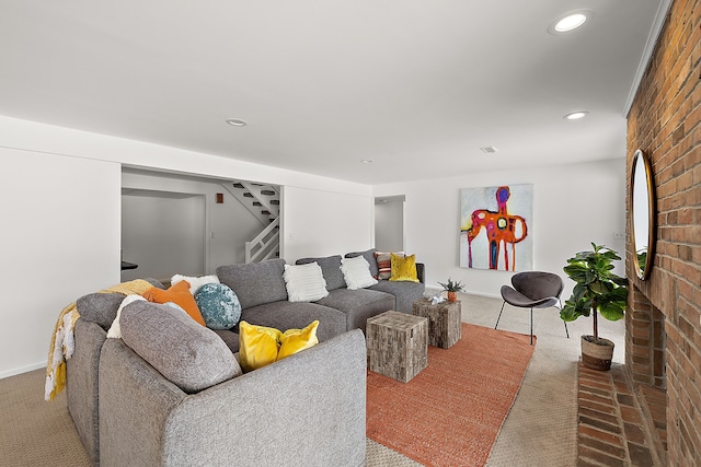 carpeted living room with brick wall, stairs, and recessed lighting