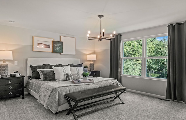 bedroom featuring a chandelier and carpet