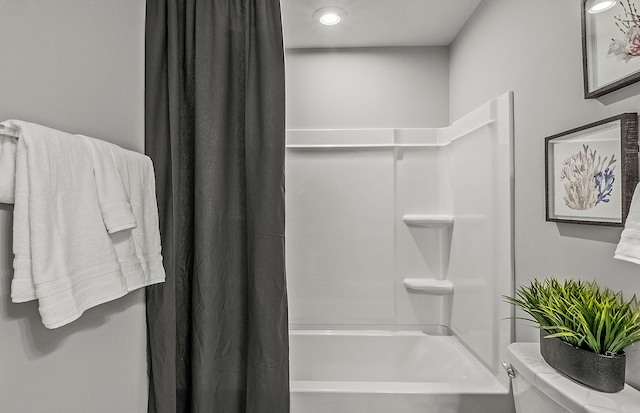 bathroom with toilet and shower / bath combo