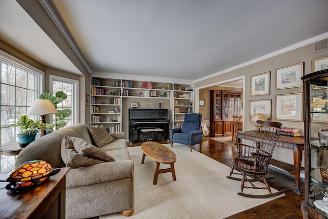 living room with hardwood / wood-style floors, crown molding, and built in features