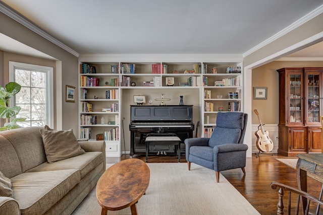 sitting room featuring crown molding, dark hardwood / wood-style floors, and built in shelves