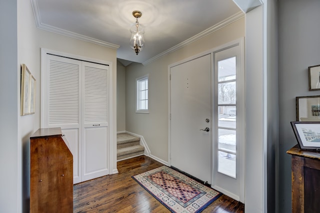 entryway with dark hardwood / wood-style flooring and ornamental molding