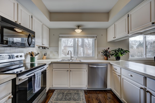 kitchen with sink, white cabinets, and appliances with stainless steel finishes