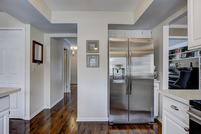 kitchen featuring white cabinetry, stainless steel refrigerator with ice dispenser, stove, and dark hardwood / wood-style flooring