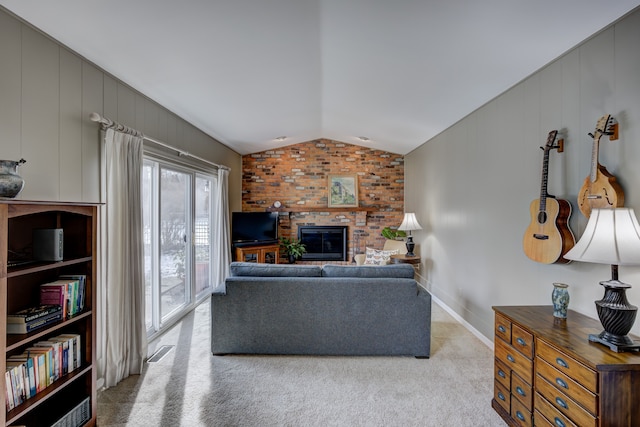 living room featuring vaulted ceiling, a brick fireplace, and light carpet