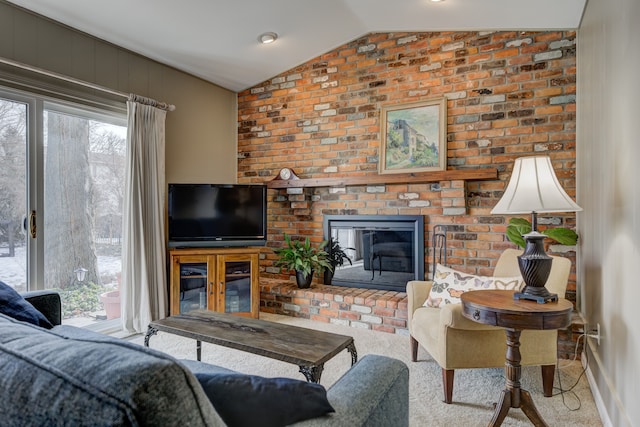 carpeted living room featuring lofted ceiling and a brick fireplace