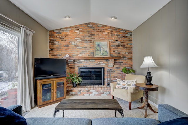 carpeted living room with vaulted ceiling and a fireplace