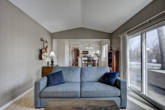 carpeted living room featuring lofted ceiling and an inviting chandelier