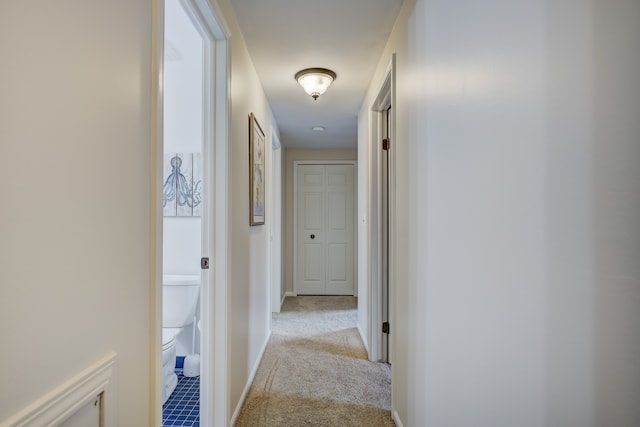 hall with light colored carpet