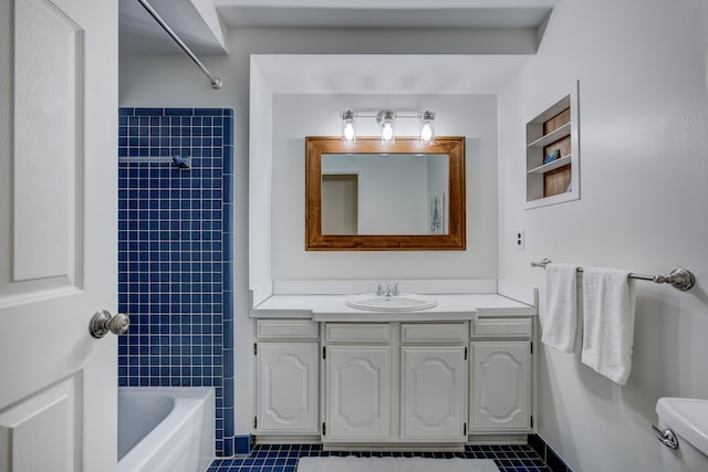 full bathroom featuring tiled shower / bath combo, vanity, tile patterned flooring, and toilet