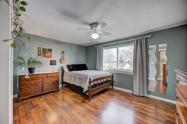 bedroom featuring dark hardwood / wood-style flooring and ceiling fan