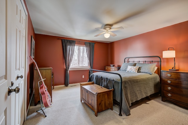 bedroom with light carpet and ceiling fan