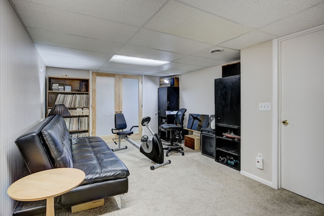 exercise area featuring carpet floors and a drop ceiling